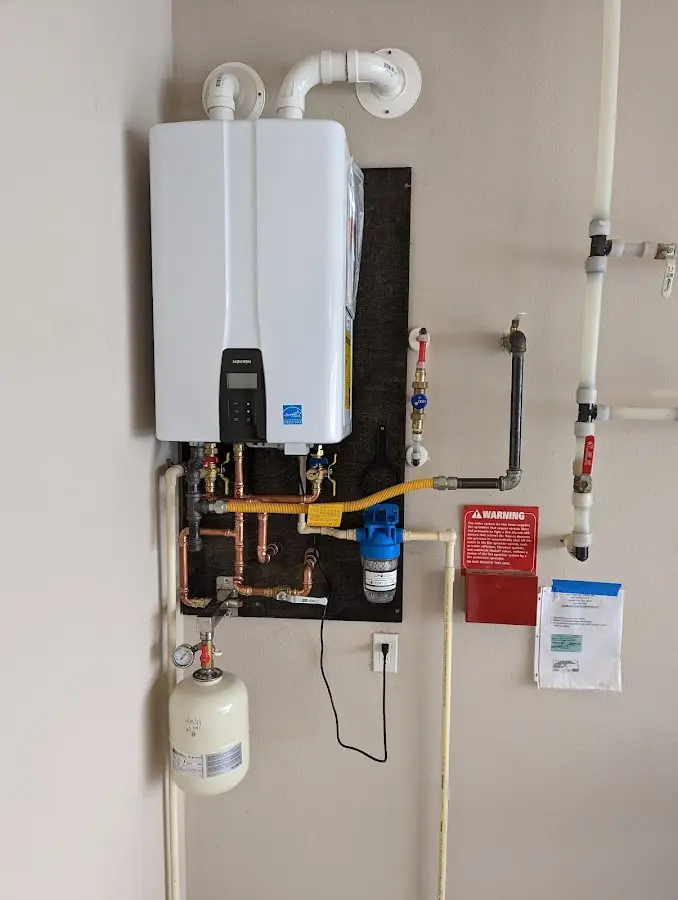 Professional plumber installing copper piping in a Gregg home